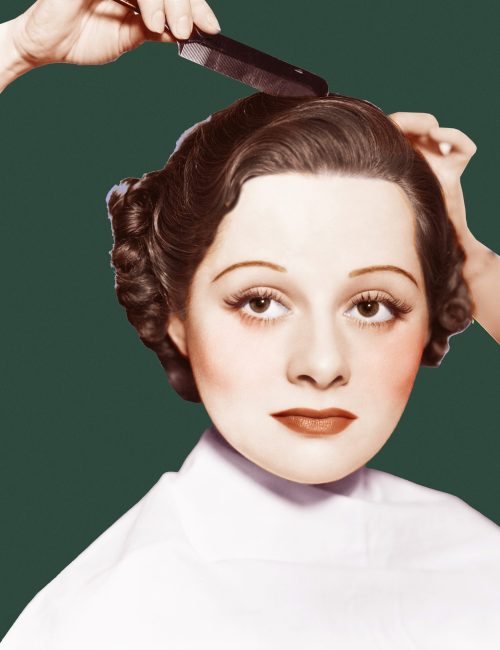 Hairdresser combing a young woman's hair